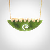 This picture shows a hand carved jade half-shield with Koru pendant. It is a semi-translucent green colour. This is a wonderful piece of jewellery. The cord is hand plaited and adjustable so that you can position the pendant where it suits you best. This piece was carved for us by Ric Moor. Delivery is free worldwide.